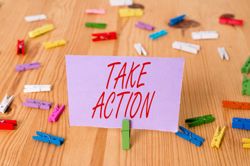 Handwriting text Take Action. Conceptual photo Supporting what you say not just words but through evidence Colored clothespin papers empty reminder wooden floor background office