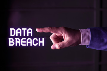 Handwriting text writing Data Breach. Conceptual photo security incident where sensitive protected information copied Isolated hand pointing with finger. Business concept pointing finger