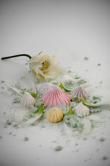 multicolored marshmallows and flowers on a white background