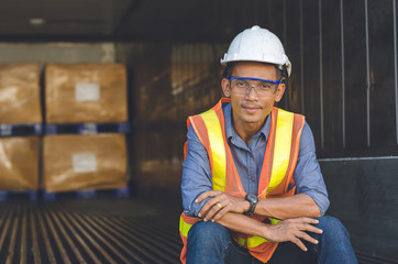 The foreman was smiling happily in the shipping container.