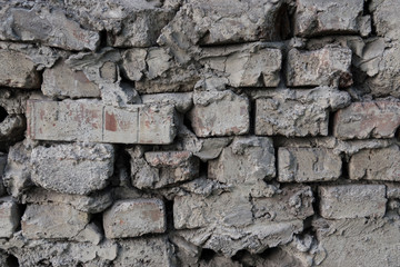 Old brickwork. Large gaps. Excess concrete mortar.