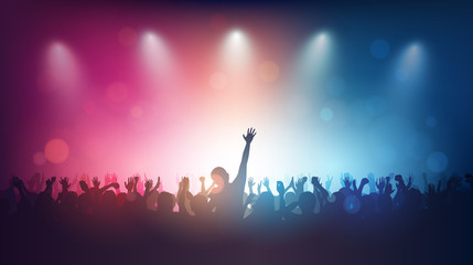 Silhouette of people raise hand up in music concert with red and blue color spotlight on stage background