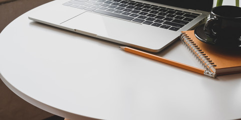 Workplace with laptop computer and office supplies on white table with copy space