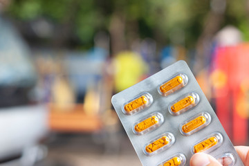 Nurse holding a yellow pill