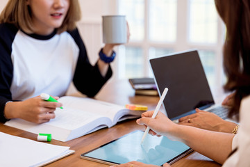 Group of asian university students concentrated on study or working together at library. preparing for exams. indoor