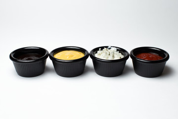 different sauces in assortment in black sauces
