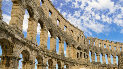 The northern part of the wall of the amphitheater in the city of Pula against the sky, inside view