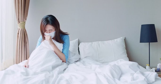 asian woman cough in bedroom