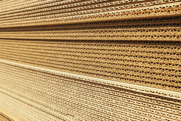 Background and texture of a stack of packaging cardboard in the sun...