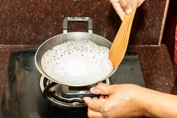 Preparation of Paalappam, Kerala's dish, in a appa chatti, nonstick pan