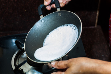 Preparation of Paalappam, Kerala's dish, in a appa chatti, nonstick pan