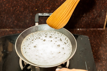 Preparation of Paalappam, Kerala's dish, in a appa chatti, nonstick pan