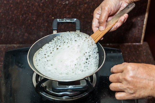 Preparation of Paalappam, Kerala's dish, in a appa chatti, nonstick pan