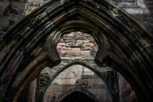 Symmetrical close up of the remains of a marble gothic pointed arch