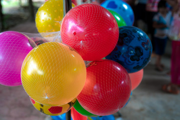 Small balloons in colorful nets are on the market