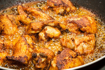Closeup of marinated chicken frying in oil. Kerala style frying