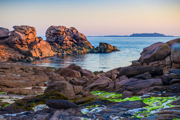 Fototapeta na wymiar The incredible Pink Granite Shore near the village of Plumanach at sunrise.The coast of Pink Granite is a unique place in Brittany. France
