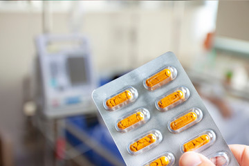 Nurse holding a yellow pill
