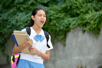 Fototapeta premium Youthful Filipina Girl Student Yelling With School Books