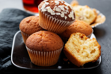 Homemade muffins with almond flakes and raspberry jam.