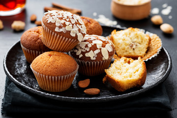 Homemade muffins with almond flakes and raspberry jam.