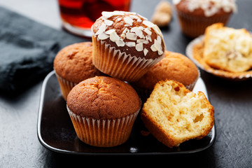 Homemade muffins with almond flakes and raspberry jam.