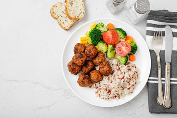 Homemade meatballs with fried rice and broccoli salad, portion for lunch or dinner. Top view.