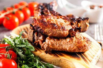 Grilled ribeye beef steak with tomatoes, herbs and spices. Selective focus