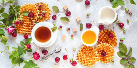 Obraz na płótnie Canvas Tea, honey, cherry, milk and wafers.