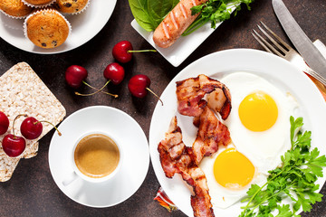 Flat lay of concept breakfast with setting food products over darken background. Top view