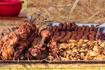 Culinary Buffet with healthy take away meal - grilled vegetables, fish and meat on the street food culinary market, festival, event.  Different types of delicious meat. Outdoor Cuisine.
