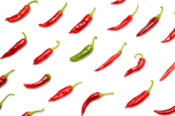Texture of red hot chili peppers on white background. Individuality, originality and uniqueness concept