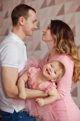 Obraz na płótnie Canvas happy family with a baby in their arms
