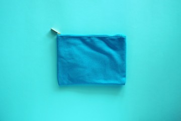 Lady fabric bag on blue background for cosmetics and beauty concept