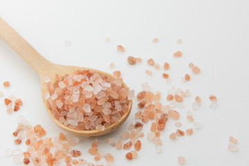 Fototapeta na wymiar Himalayan salt in wooden spoon on white background