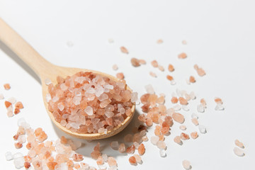 Fototapeta na wymiar Himalayan salt in wooden spoon on white background