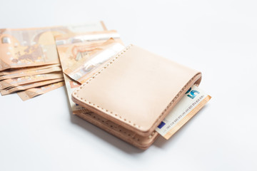 Leather wallet with euro money bill on white background