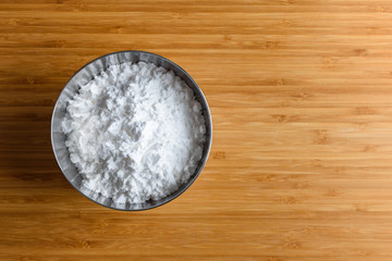 Top view tapioca starch powder in wooden bowl background isolate