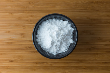 Top view tapioca starch powder in wooden bowl background isolate