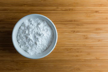 Top view tapioca starch powder in wooden bowl background isolate