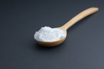 Top view tapioca starch/flour powder in white bowl with wooden background, spoon and fork
