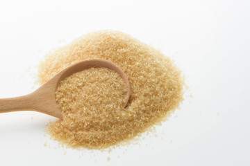 Brown sugar background with wooden spoon