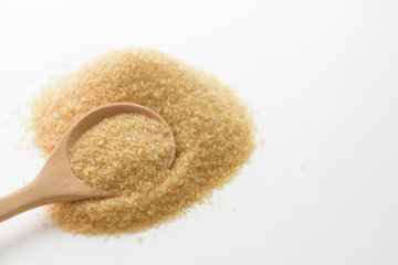Brown sugar background with wooden spoon
