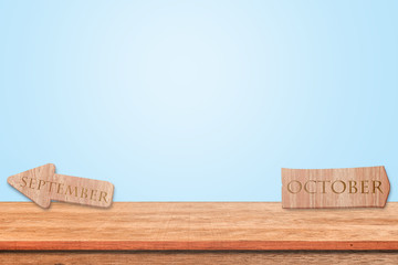 Wood sign alphabet september and october put on the table wooden with blue background. Copy space for text.