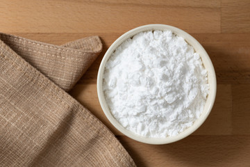 Top view mung bean starch powder in white bowl with wooden background