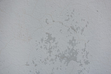 Cracked painted concrete wall background and texture