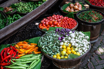 fresh vegetable on a market place colorful eggplants, chili, tomatoes, onion , salad
