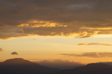 Silhouette of Mountain With Fluffy Clouds during Sunrise