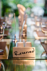 Reserved Metal Plate on the Table with Blurry background. Reservation Seat at restaurant.