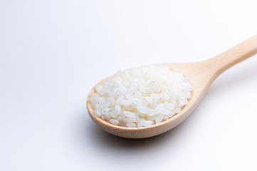 Fototapeta na wymiar Top view of Japanese rice on wooden spoon white background isolate